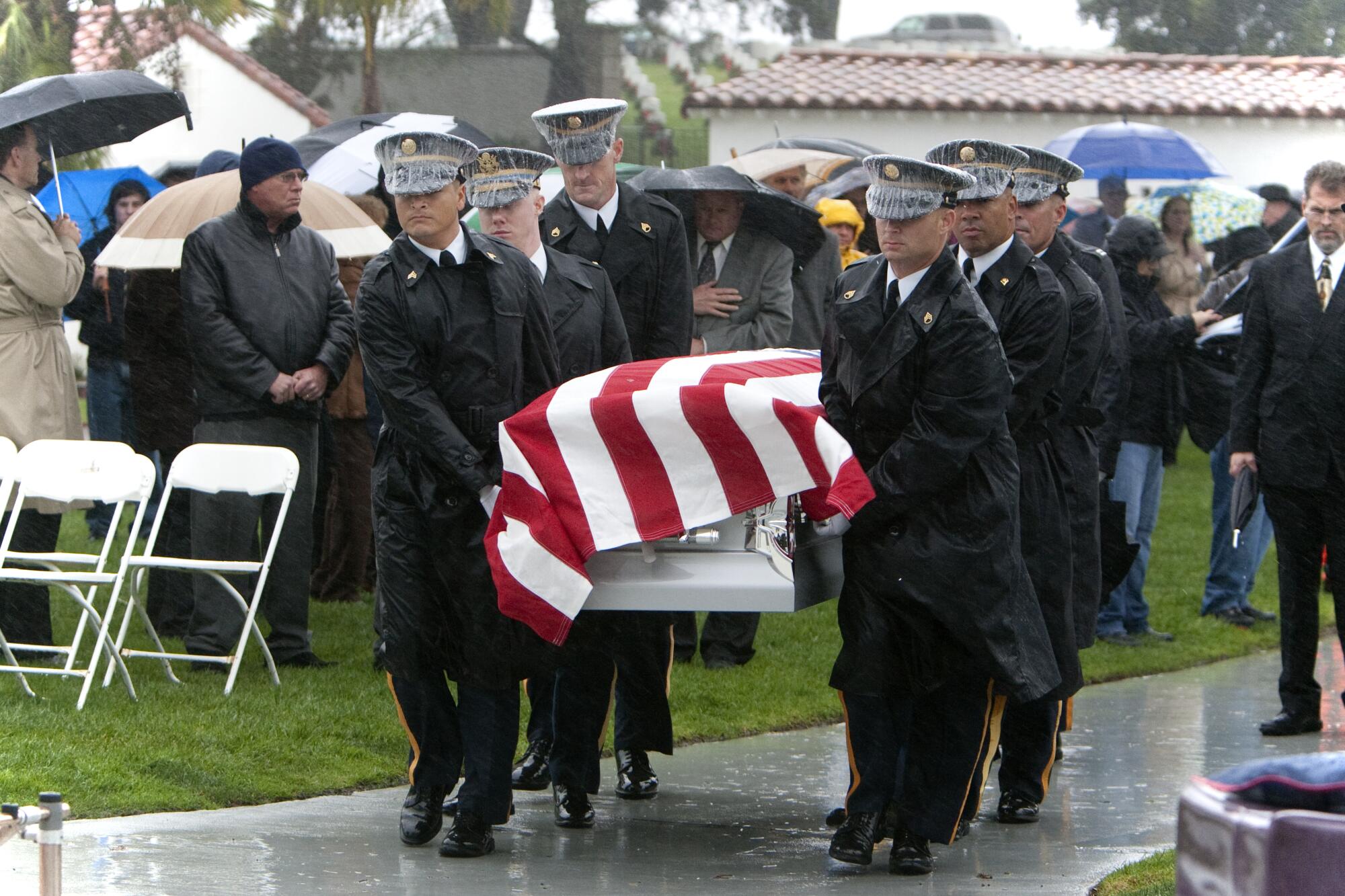 Pallbearers carry a casket at a military funeral