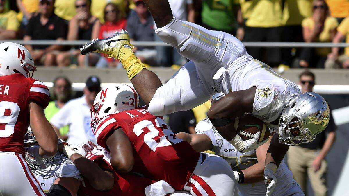 Oregon running back Royce Freeman leaps over the Nebraska defense for a touchdown during the second quarter Saturday.