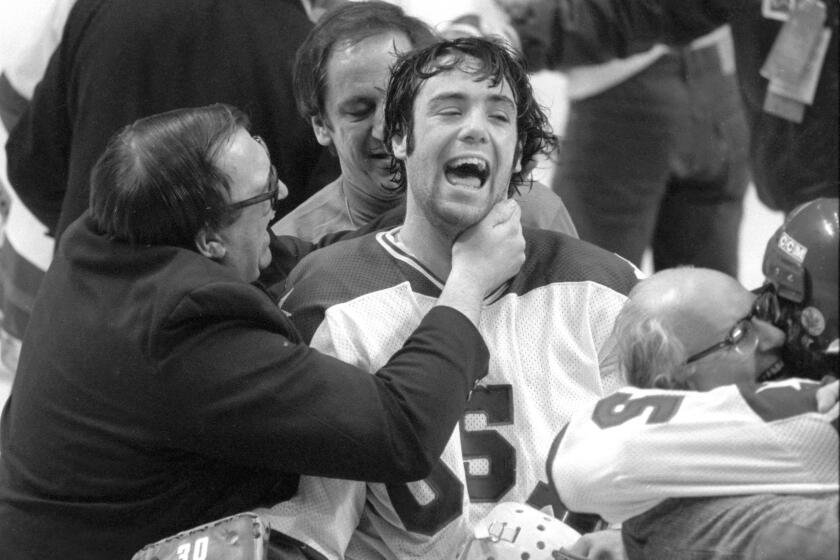 In this Feb. 22, 1980, photo, U.S. goaltender Jim Craig got a hug from goalie coach Warren Strelow after the Americans beat the Soviet Union at the Winter Olympics.