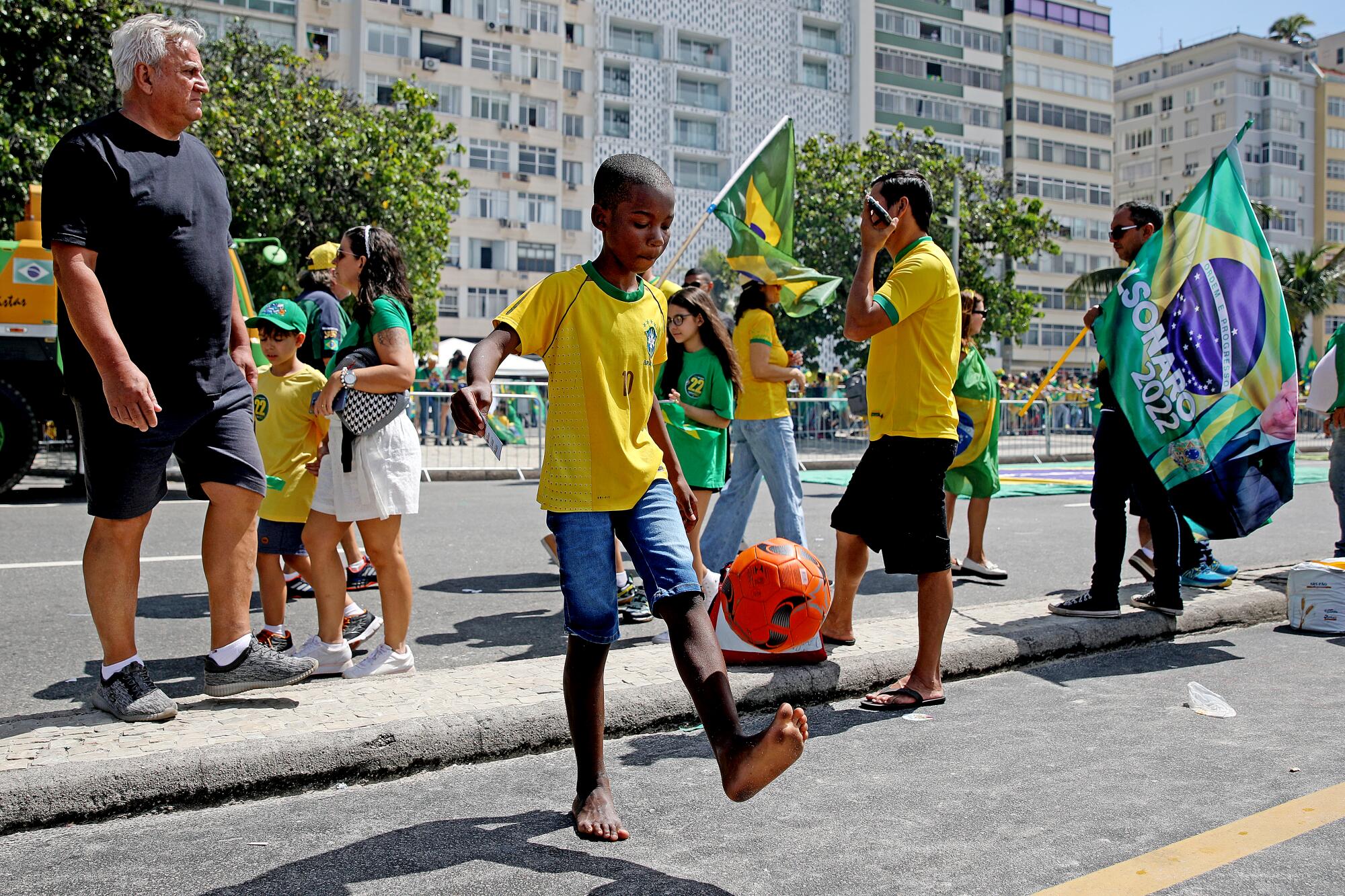  A young boy plays with a soccer ball during rally.