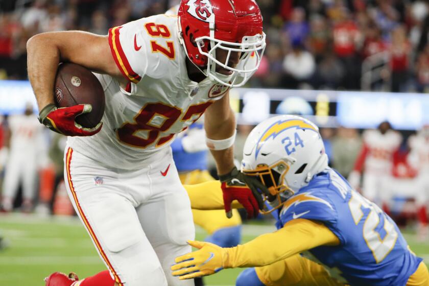 Los Angeles, CA - November 20: Kansas City Chiefs tight end Travis Kelce (87) runs past Los Angeles Chargers safety Nasir Adderley (24) after a catch for a touchdown during the fourth quarter at SoFi Stadium on Sunday, Nov. 20, 2022 in Los Angeles, CA. (Robert Gauthier / Los Angeles Times)