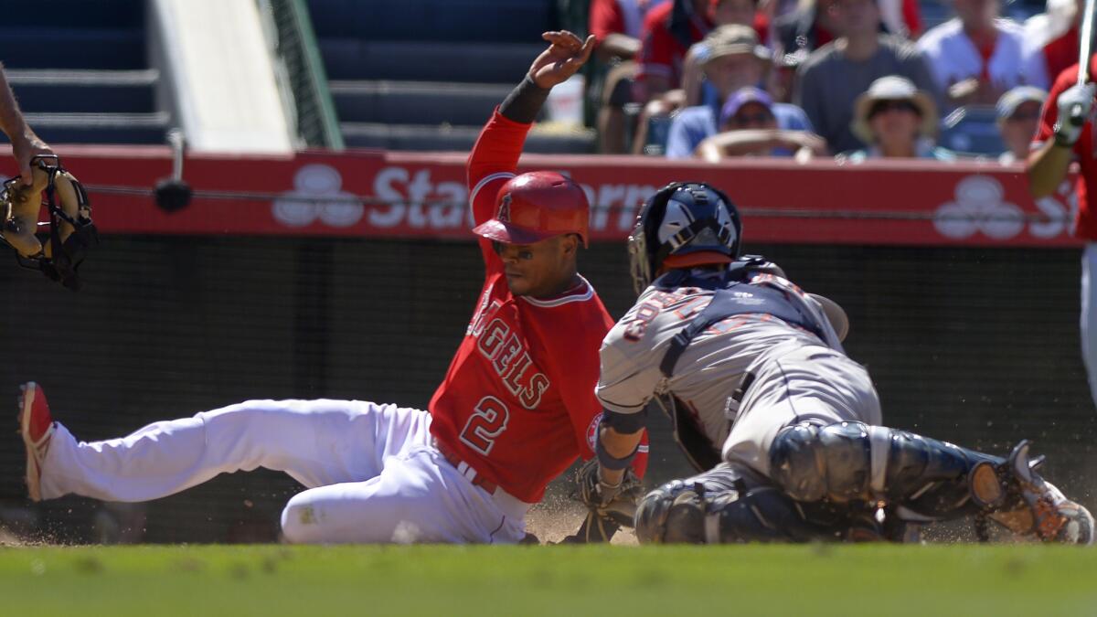 Angels baserunner Erick Aybar, left, slides safely into home as Houston Astros catcher Carlos Corporan makes a late tag during the eighth inning of the Angels' 6-1 win Sunday.