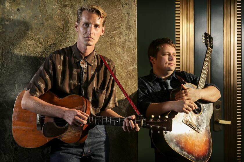 Tom Brosseau, left, and his collaborator Sean Watkins stand in the lobby of the Los Angeles Times building, Jan. 30, 2014.