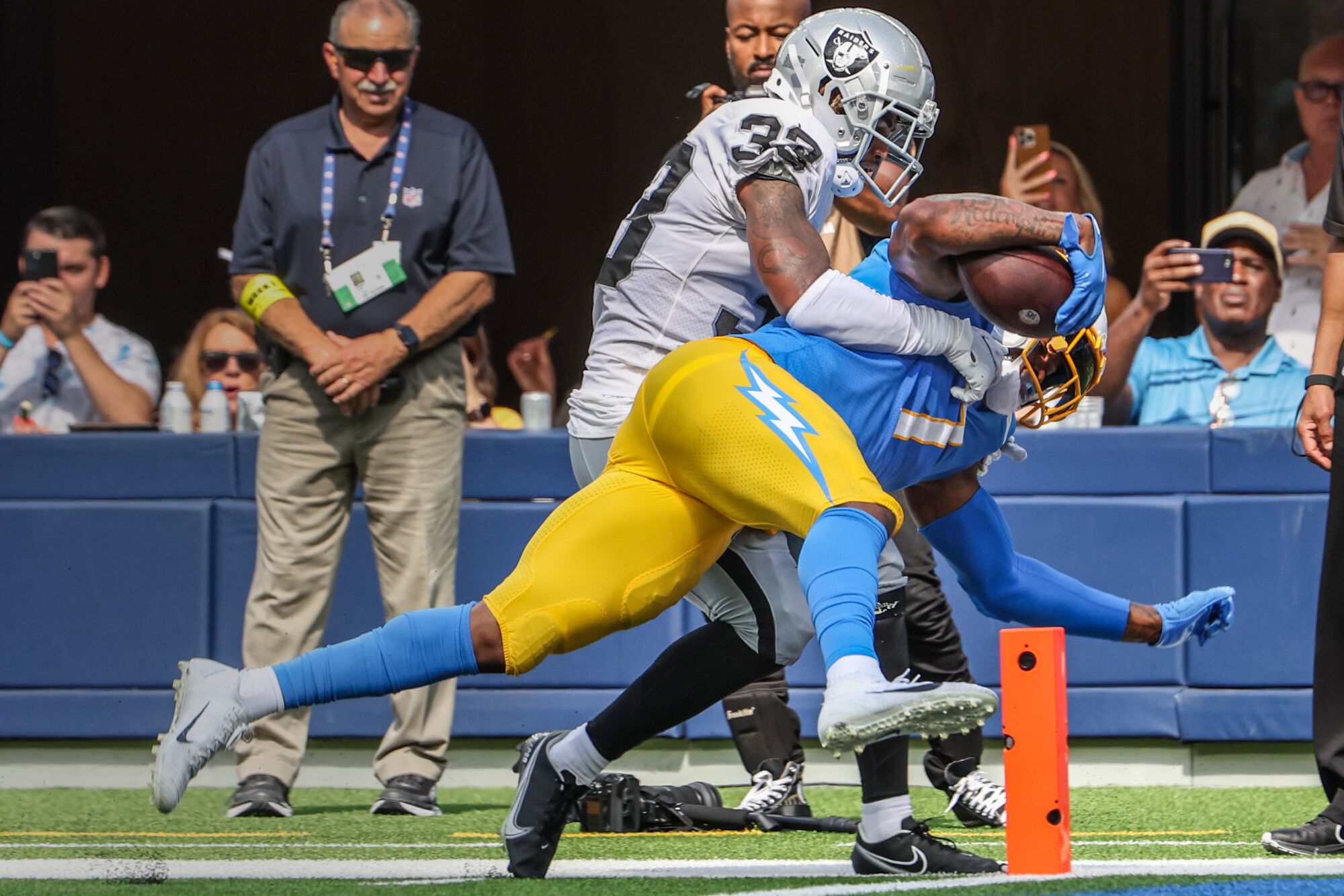 Chargers tight end Gerald Everett pushes into the end zone past Raiders safety Roderic Teamer.