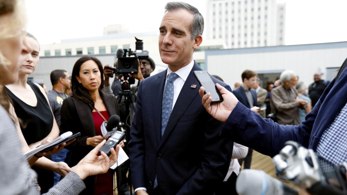 Mayor Eric Garcetti takes questions Wednesday at the site of a temporary homeless shelter about to open in downtown Los Angeles.