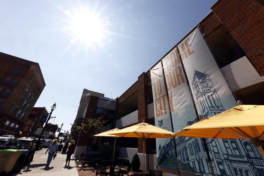 Pedestrians walk down Fountain Avenue in Springfield, Ohio, Wednesday, Sept. 11, 2024. (AP Photo/Paul Vernon)