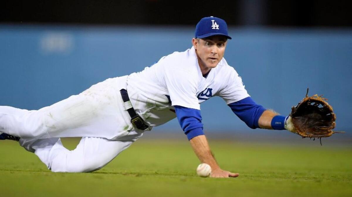 Dodgers second baseman Chase Utley dives for a ball hit by Cubs infielder Ben Zobrist during a game on Aug. 26.