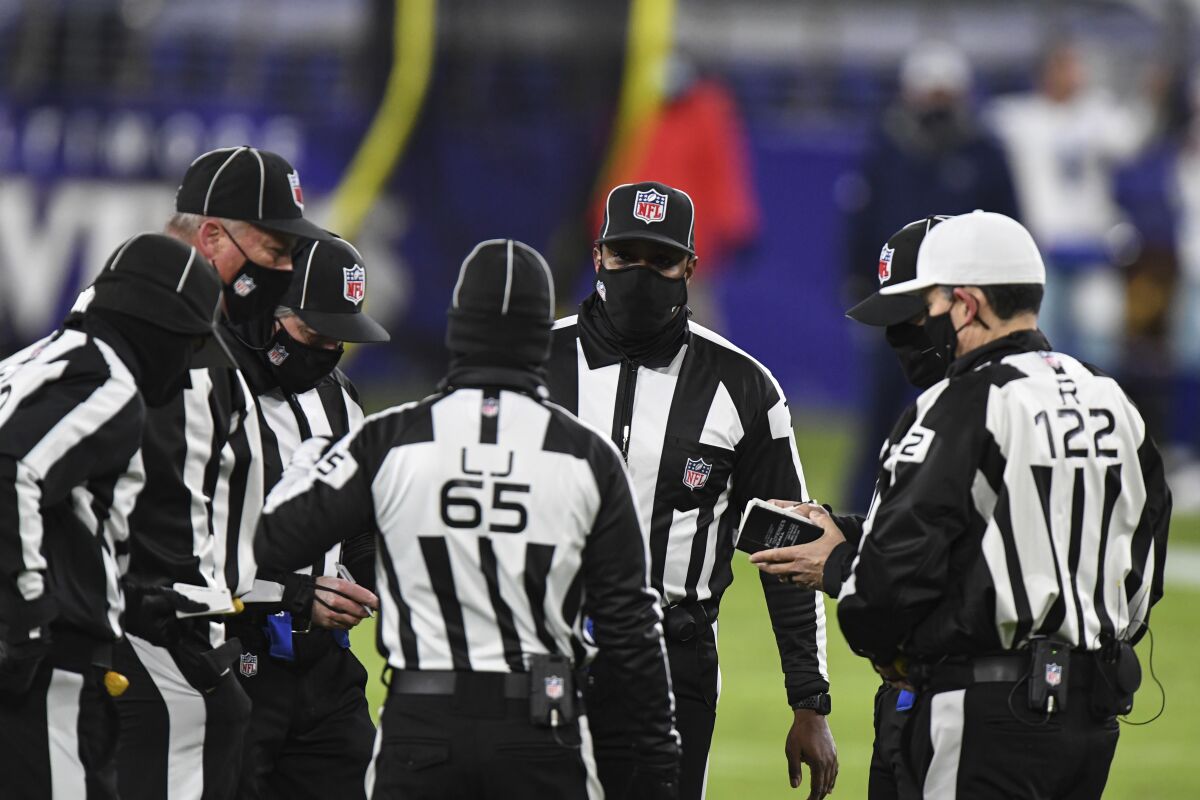 NFL officials huddle during the second half between the Baltimore Ravens and the Dallas Cowboys.