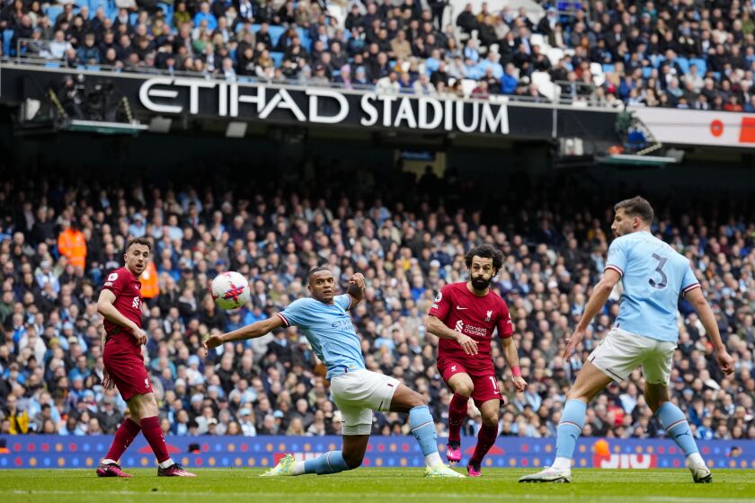Liverpool's Mohamed Salah, second from right, scores his side's opening goal during the English Premier League soccer match between Manchester City and Liverpool at Etihad stadium in Manchester, England, Saturday, April 1, 2023. (AP Photo/Jon Super)