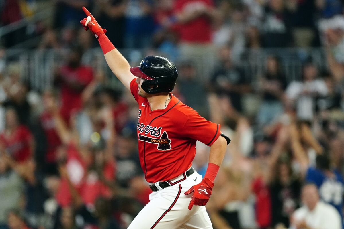 Atlanta Braves' Austin Riley gestures as he runs the bases after hitting a three-run home run in the third Inning of a baseball game against the Houston Astros Friday, Aug. 19, 2022, in Atlanta. (AP Photo/John Bazemore)
