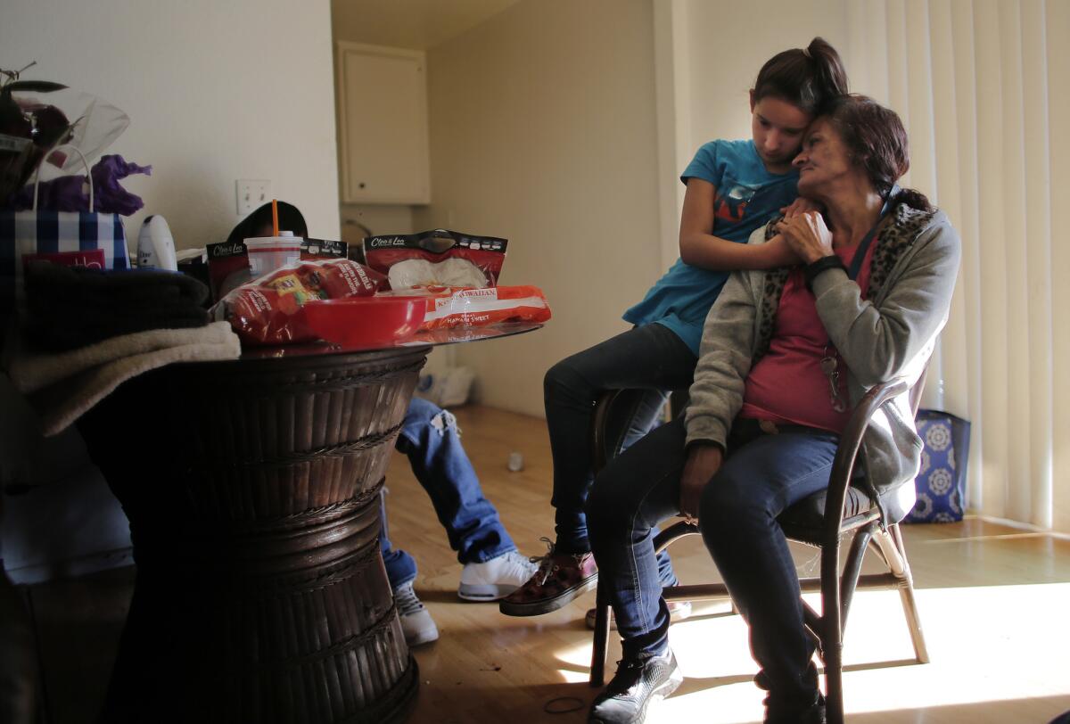 Regina Bejarano comforts her granddaughter Honestie Diaz, 10, at her home in San Bernardino.