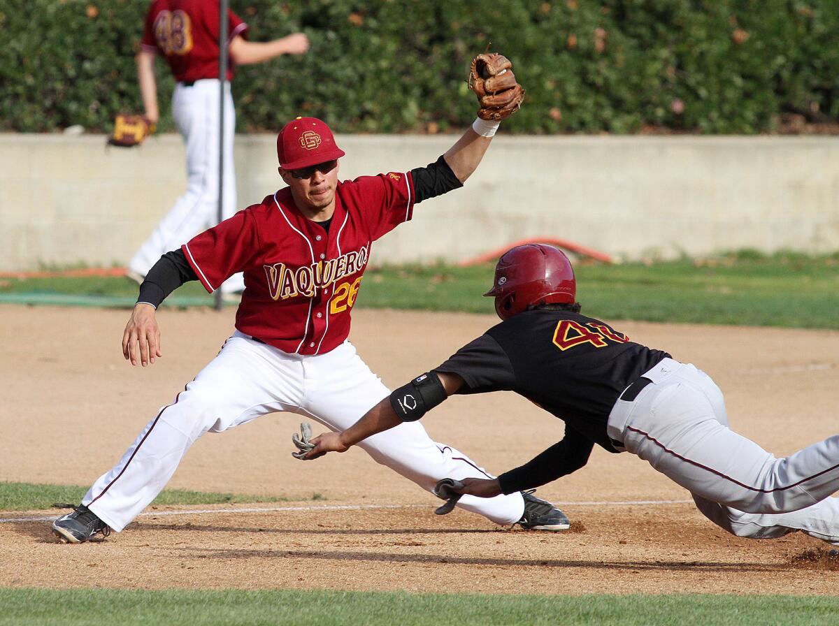 GCC third baseman Randy Medellin catches the ball and tags out Lino Lares at third base in a scrimmage against the other half of the GCC team at Stengel Field in Glendale on Wednesday, January 22, 2014.