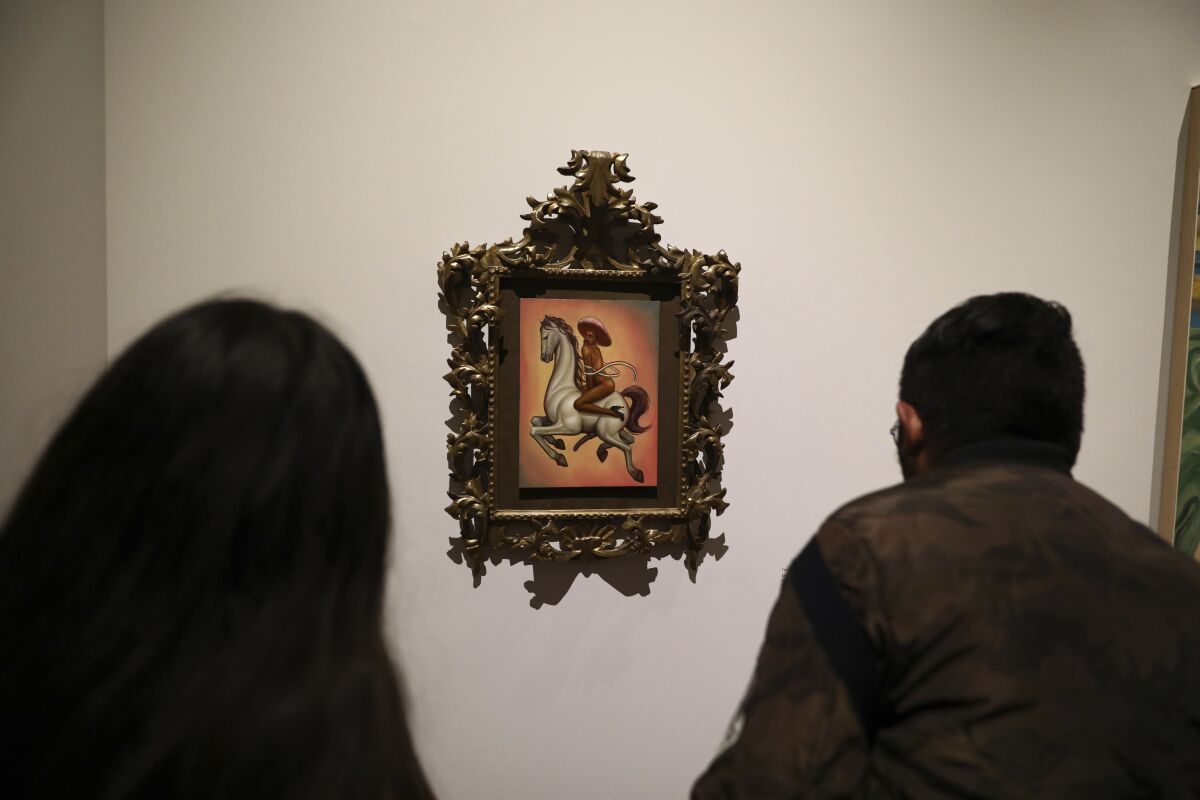 People view a painting of a nude Emiliano Zapata at the Palacio de Bellas Artes