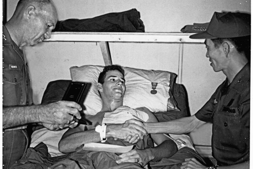 From the book by veteran John Musgrave, author of "The Education of Corporal John Musgrave." I receive the Purple Heart while recovering in a hospital bed at Third Medical Battalion, Phu Bai. Left to right, Gen. Bruno Hochmuth, CO Third Marine Division, Gen. Hoàng Xuân Lãm, CO Vietnamese Eleventh Division. Credit to John Musgrave