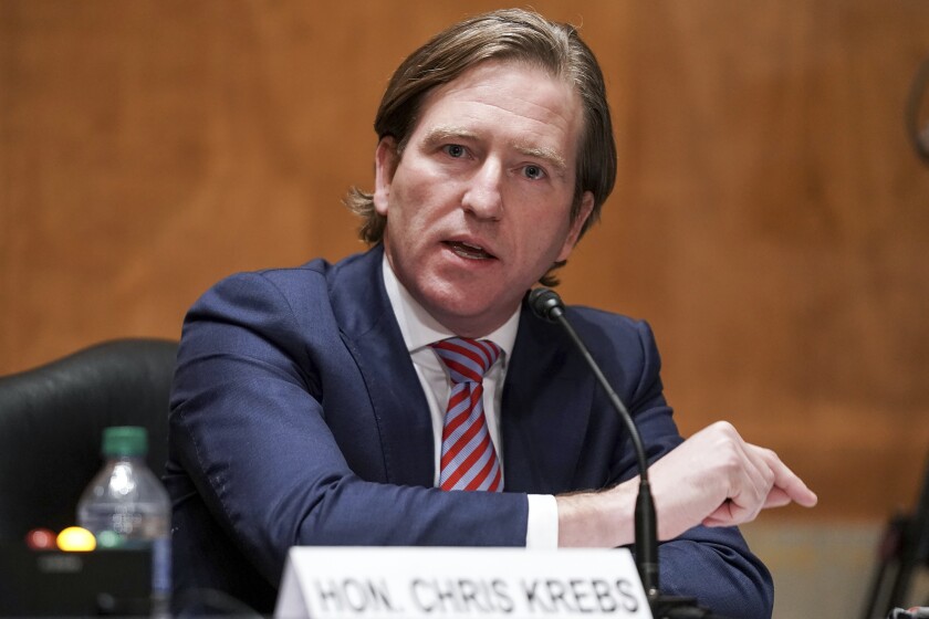 Christopher Krebs speaks into a microphone as he testifies before a Senate committee on Dec. 16.