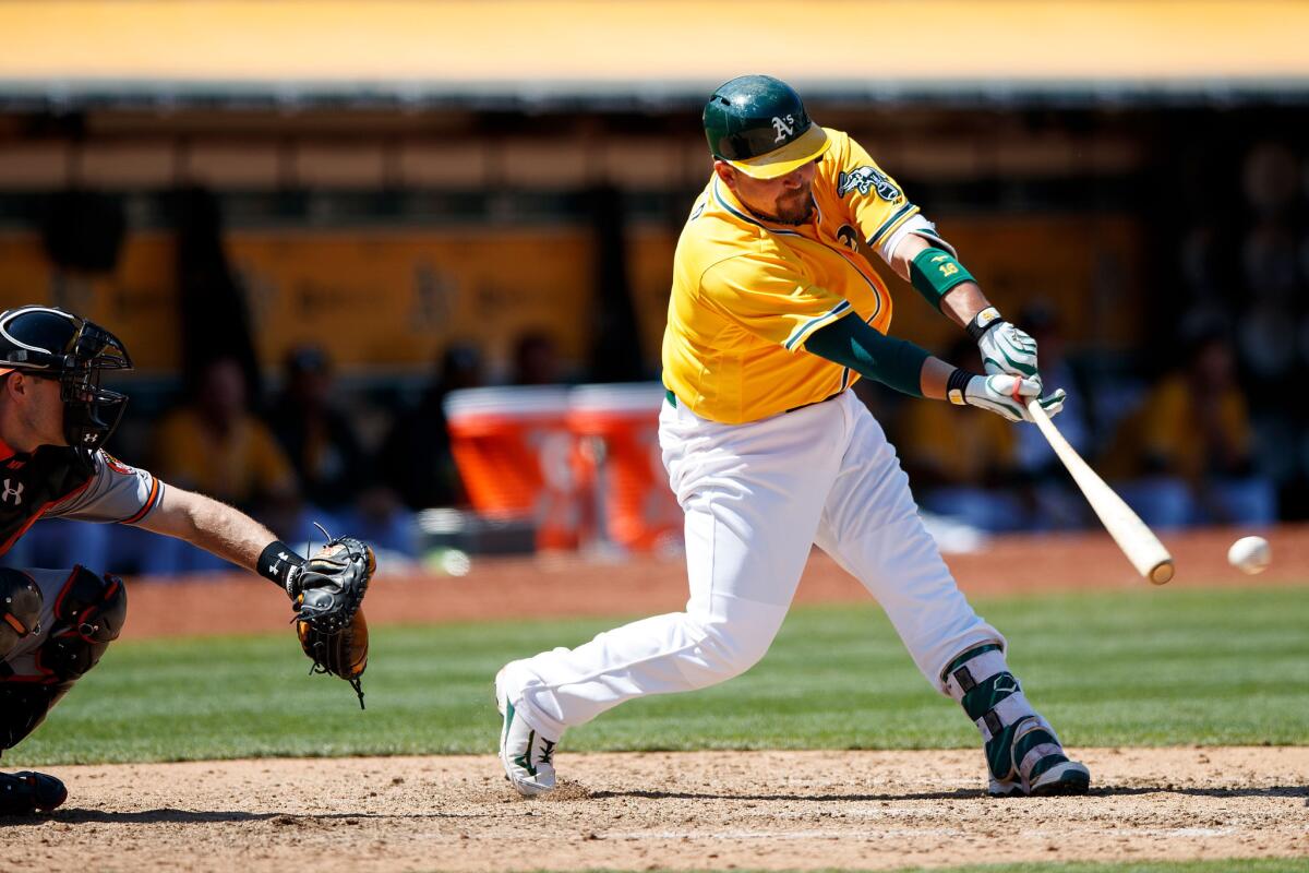 Athletics slugger Billy Butler (16) hits an RBI single against the Baltimore Orioles during the eighth inning on Aug. 11.