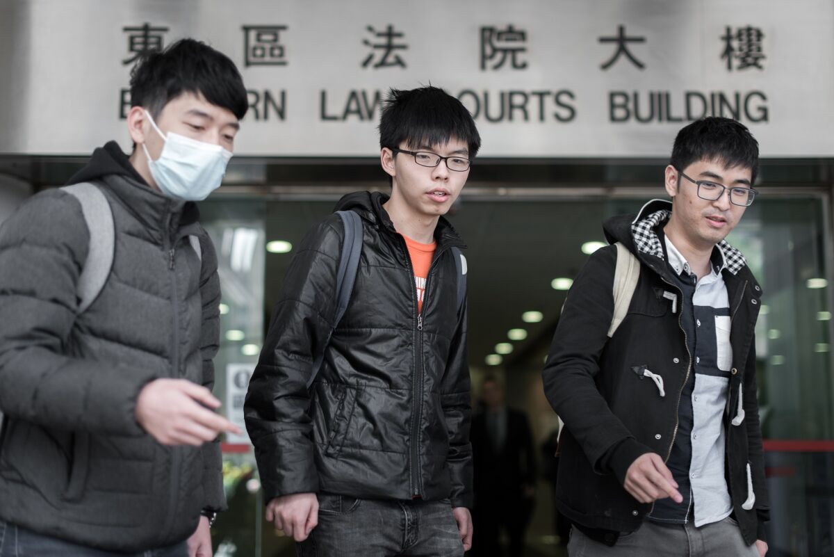 Student protesters Nathan Law, from left, Joshua Wong and Alex Chow outside a court in Hong Kong on Monday.