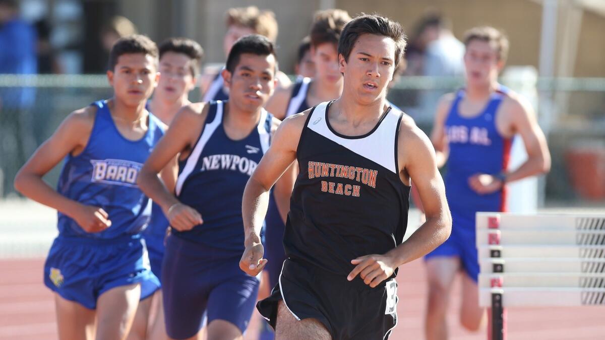 Huntington Beach High's Mitchel Lars rounds the last turn in the 1,600-meter race in the Sunset League finals at Westminster High on May 4.