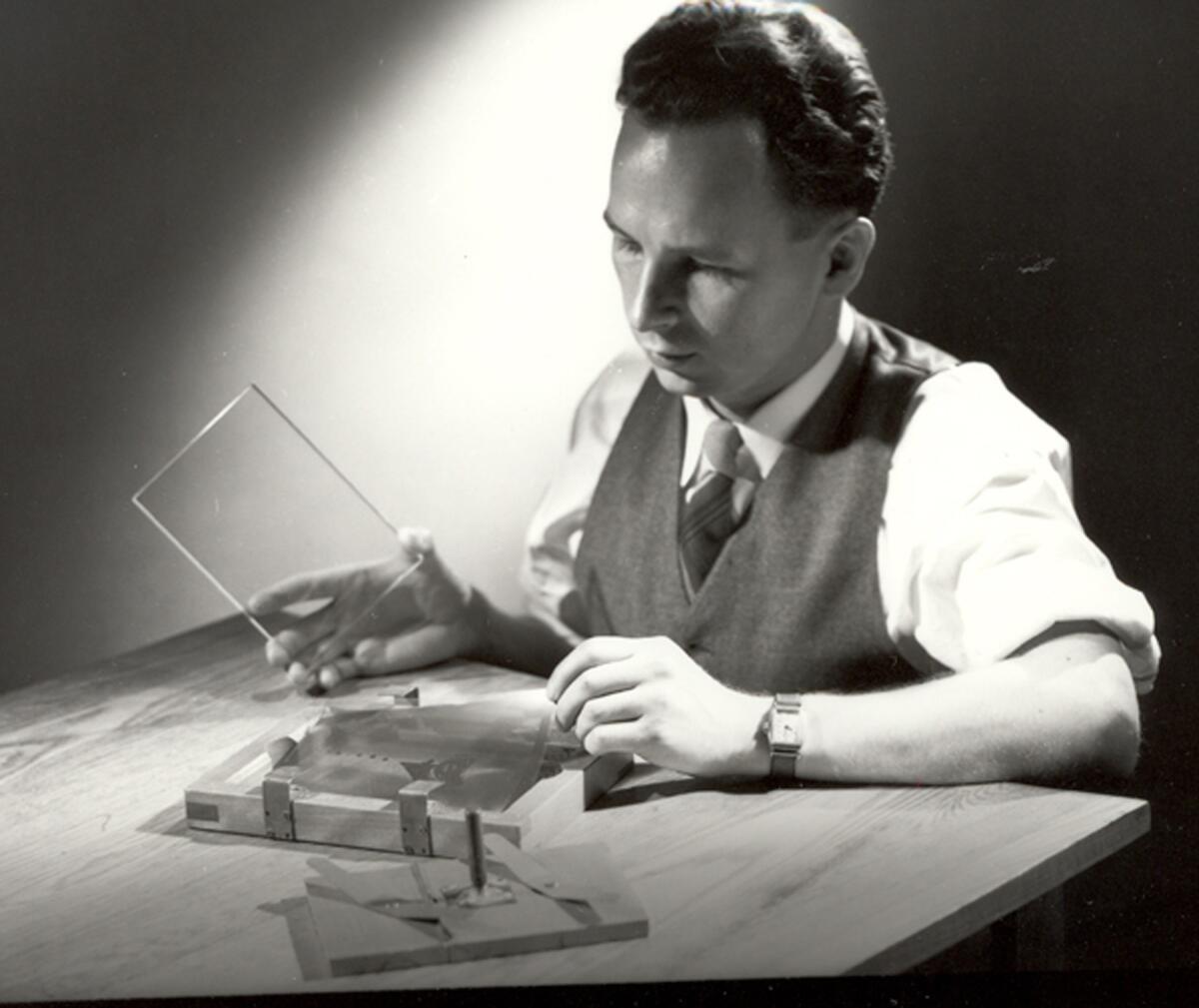 Glass scientist S. Donald Stookey prepares to expose an image to ultraviolet light in 1950. In addition to developing CorningWare, he developed photosensitive glass that helped lead to color television picture tubes. His numerous inventions generated big business for Corning.