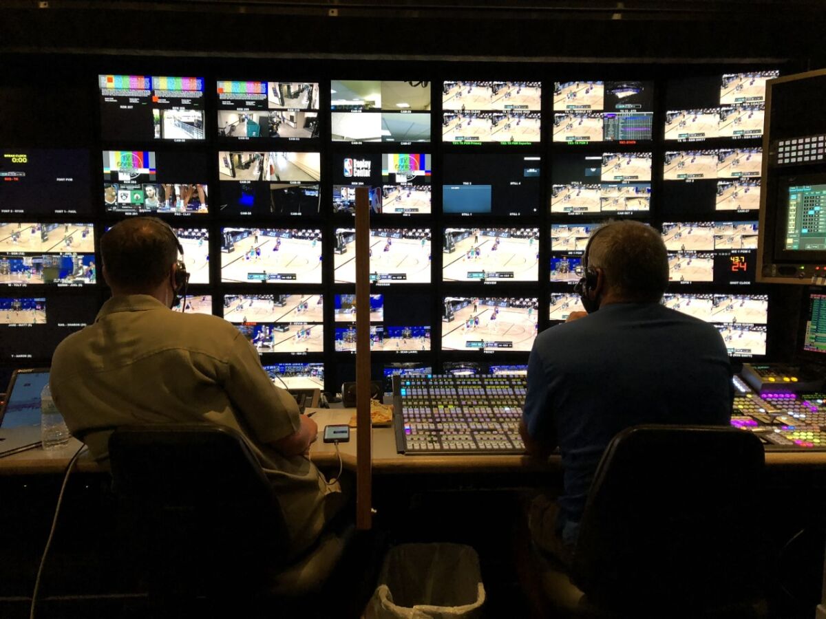 ESPN employees produce an Aug. 5 NBA game from a production truck at Disney World's Wide World of Sports Complex.