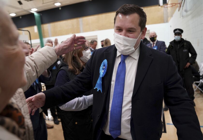 Conservative candidate Louie French celebrates victory in the Old Bexley and Sidcup by-election at Crook Log Leisure Centre in Bexleyheath, Kent, England, early Friday Dec. 3, 2021. French, won the special election which was held to replace the former MP James Brokenshire, who died from cancer in October. (Gareth Fuller/PA via AP)