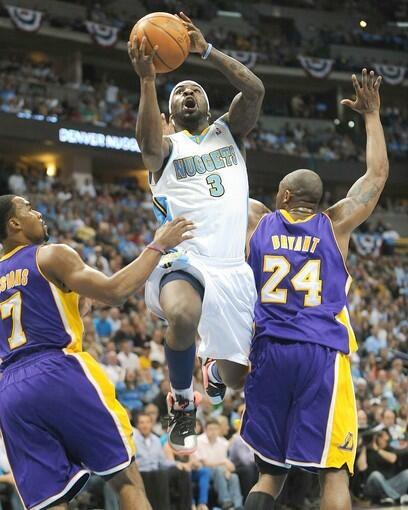 Nuggets point guard Ty Lawson, who finished with 25 points and seven assists, splits the defense of Lakers guards Ramon Sessions and Kobe Bryant for a layup in the second half of Game 3 on Friday night in Denver.