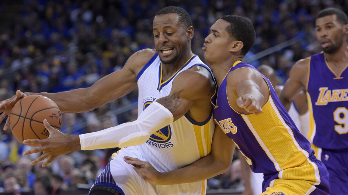 Lakers guard Jordan Clarkson tries to cut off a drive by Golden State Warriors guard Andre Iguodala during the second half of the Lakers' 127-104 loss on Nov. 1.