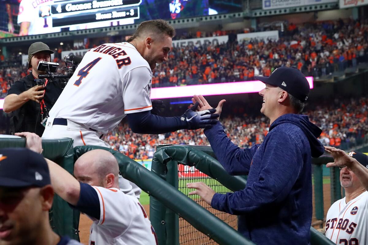 HOUSTON, TX - OCTOBER 28: George Springer #4 of the Houston Astros celebrates with manager manager A.J. Hinch #14 after hitting a solo home run during the sixth inning against the Los Angeles Dodgers in game four of the 2017 World Series at Minute Maid Park on October 28, 2017 in Houston, Texas.