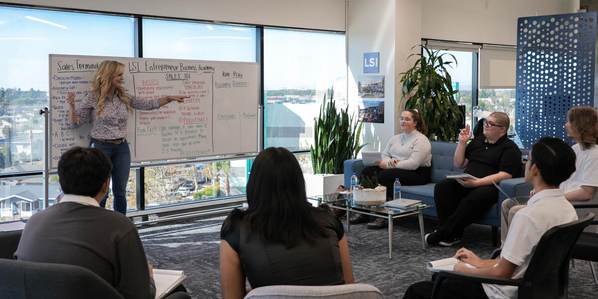 Life Science Intelligence's Kelly Williams, left, talks to Ocean View High students at LSI Entrepreneur Business Academy.