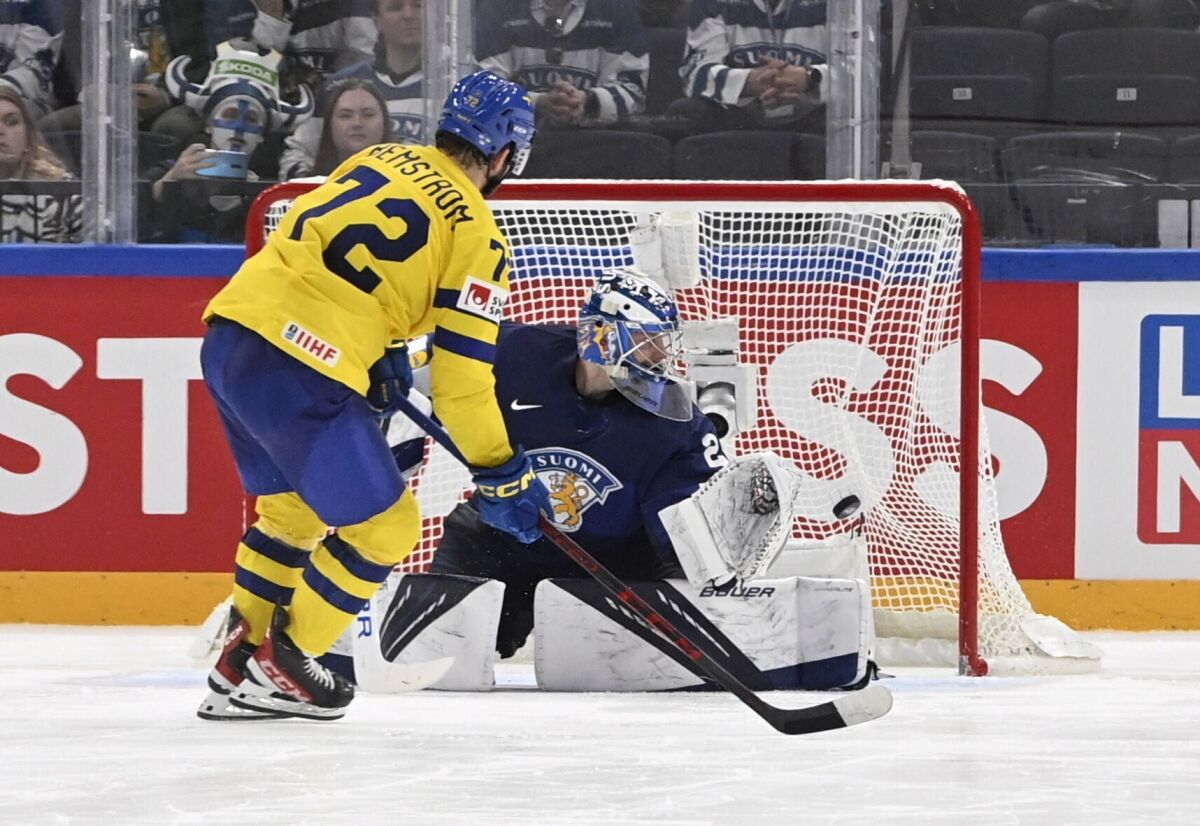 Emil Bemstr'm of Sweden scores the only and winning goal past goalkeeper Harri S'teri of Finland during the after penalty shootout during the 2022 IIHF Ice Hockey World Championships preliminary round group B match between Finland and Sweden in Tampere, Finland, Wednesday, May 18, 2022. (Heikki Saukkomaa/Lehtikuva via AP)