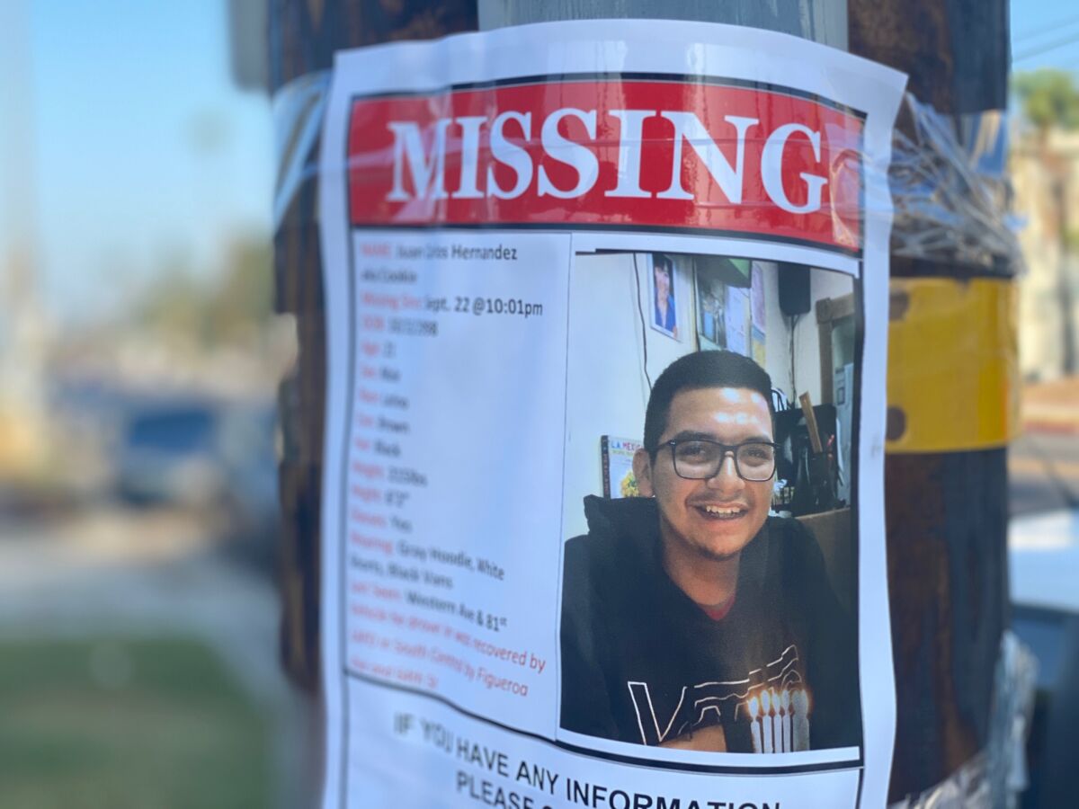 A missing-person flier taped to a utility pole seeks help in finding Juan Carlos Hernández