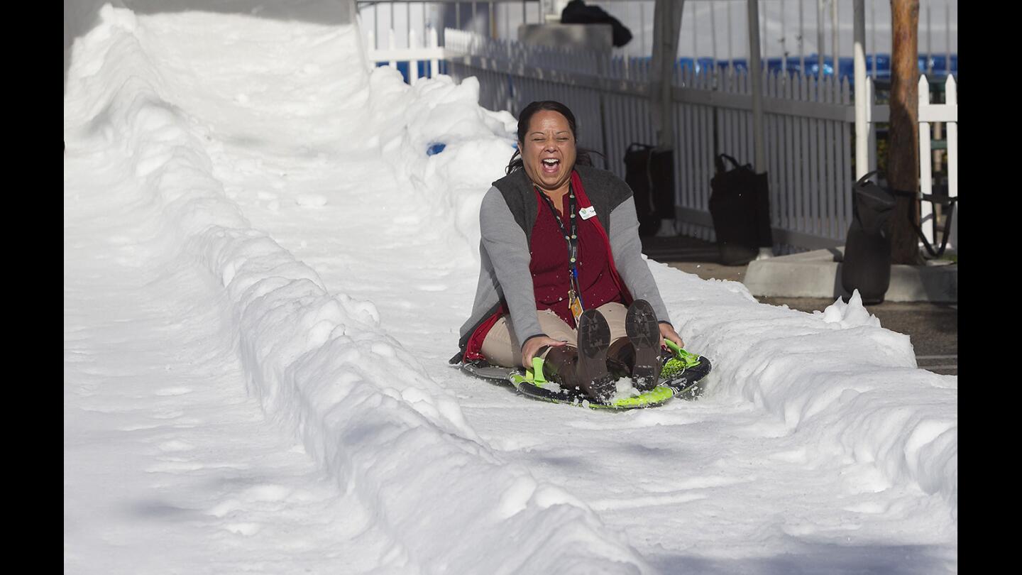 A Discovery Center worker tests one of the snow slides for safety in preparation for Discovery Cube's Winter Wonderfest opening Dec. 17 in Santa Ana.