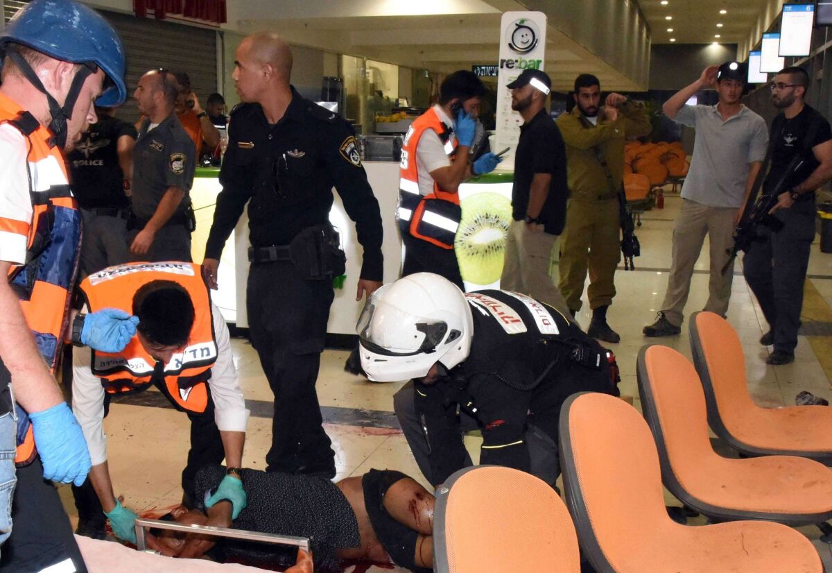 A Eritrean who was shot by an Israeli security guard and then attacked by bystanders who mistook him for an assailant in a deadly attack is evacuated at the main bus station in Beersheba, Israel, on Oct. 18. The man later died of his wounds.