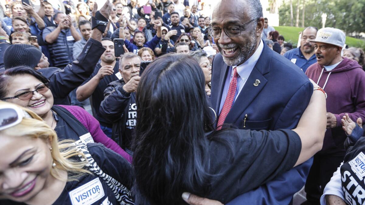 Councilman Curren Price is warmly received by vendors outside City Hall after the Los Angeles City Council voted unanimously to legalize and regulate sidewalk vending.