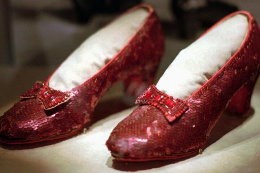 FILE - This April 10, 1996, file photo shows one of the four pairs of ruby slippers worn by Judy Garland in the 1939 film "The Wizard of Oz" on display during a media tour of the "America's Smithsonian" traveling exhibition in Kansas City, Mo. Federal authorities say they have recovered a pair of ruby slippers worn by Garland that were stolen from the Judy Garland Museum in Grand Rapids, Minn., in August 2005 when someone went through a window and broke into the small display case. The shoes were insured for $1 million. (AP Photo/Ed Zurga, File)
