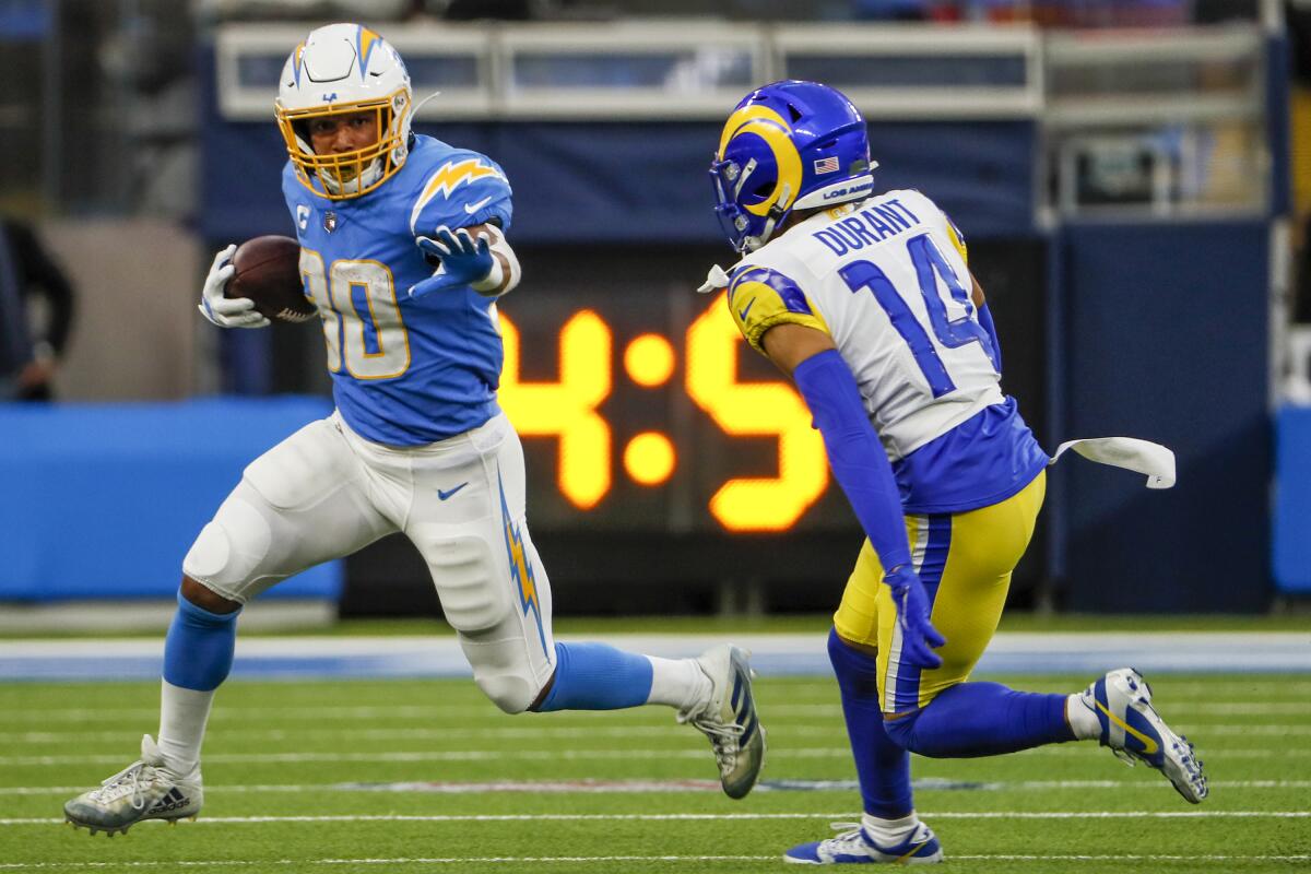  Chargers running back Austin Ekeler (30) runs past the Rams Cobie Durant.