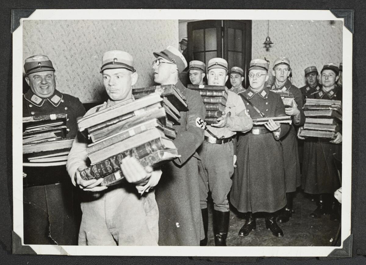 German Nazis carry Jewish books, presumably for burning, in 1938