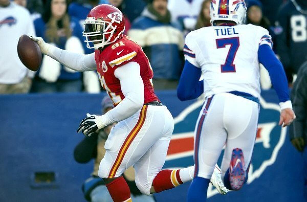 Kansas City Chiefs outside linebacker Tamba Hali (91) returns a fumble for an 11-yard touchdown ahead of Buffalo Bills quarter Jeff Tuel in the fourth quarter Sunday.