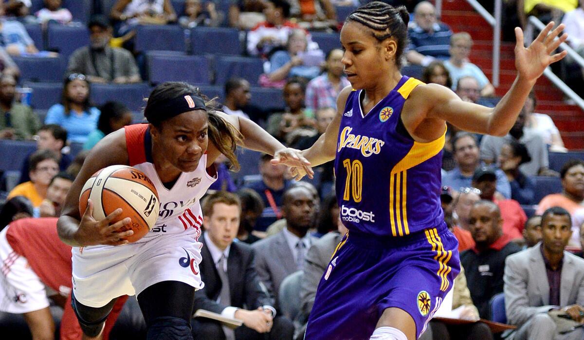Mystics guard Ivory Latta (12) drives the baseline against Sparks guard Lindsey Harding (10) during a game last month in Washington.