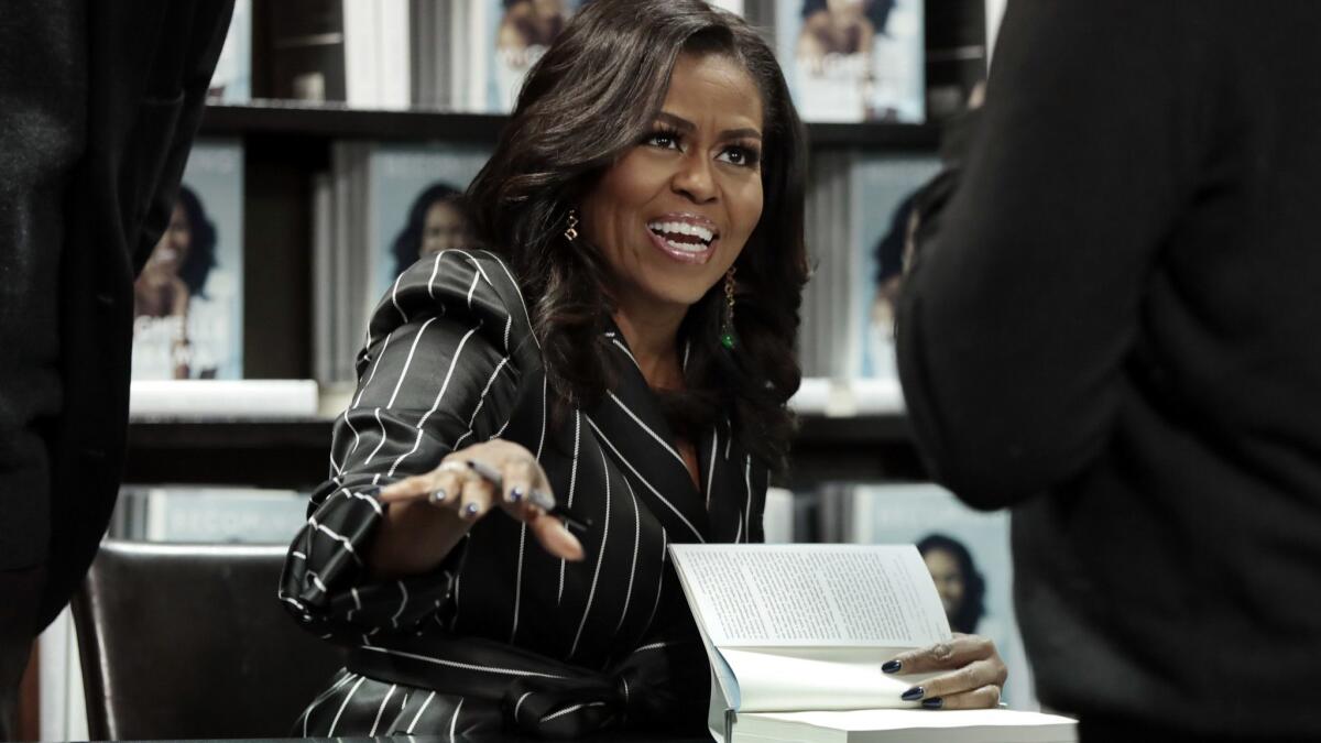 Michelle Obama signs copies of her memoir "Becoming" in New York on Nov. 30, 2018.