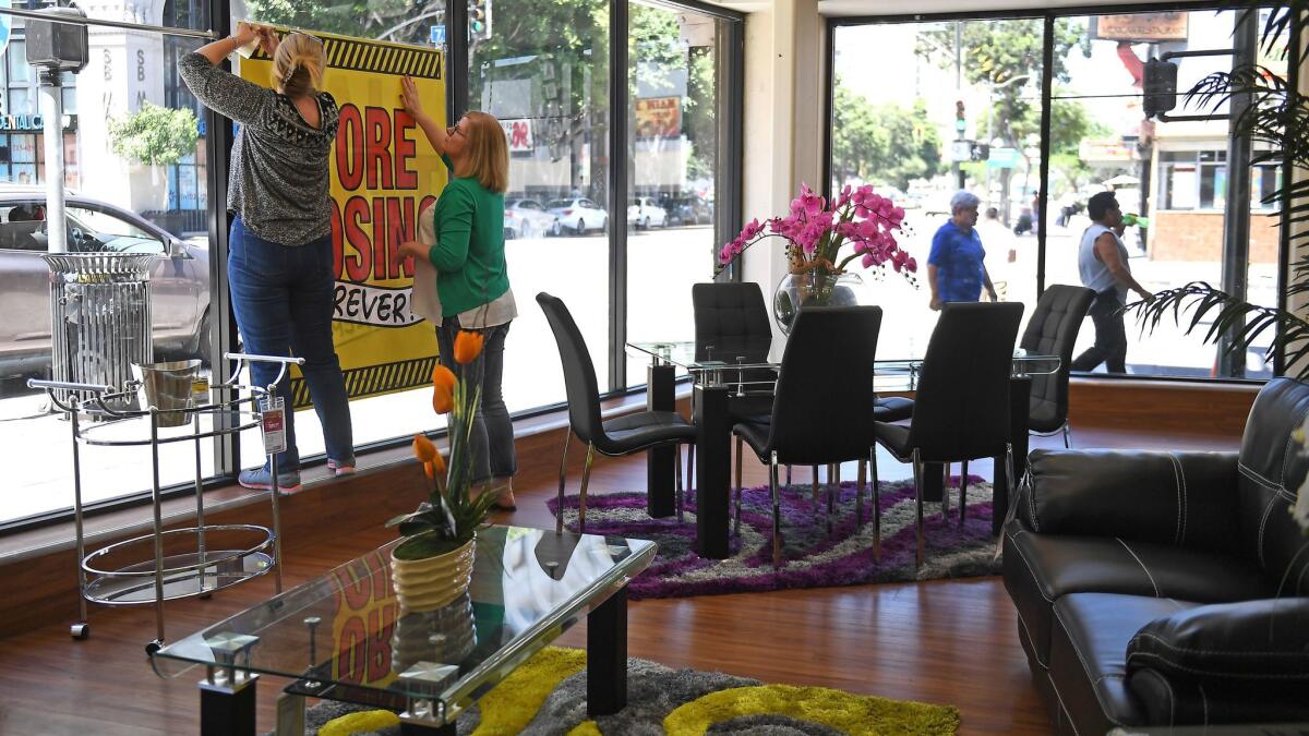 Closing signs are placed on the windows at Dearden's in downtown Los Angeles.