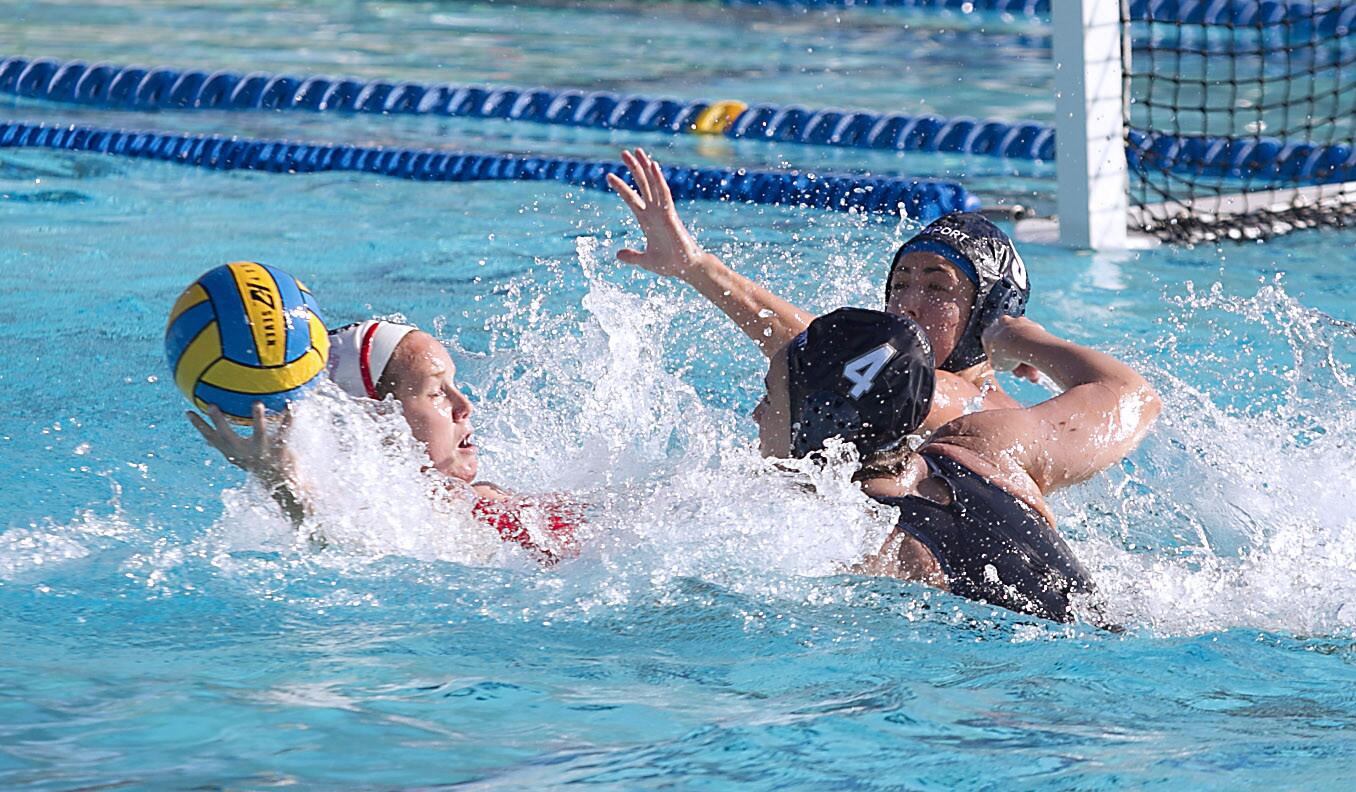 Newport's Rachael Whitelegge pressures a San Marcos shooter with help from Kate Pipkin in first half during Southern California Girl's water polo championship's third place match-up at Irvine High School on Saturday.