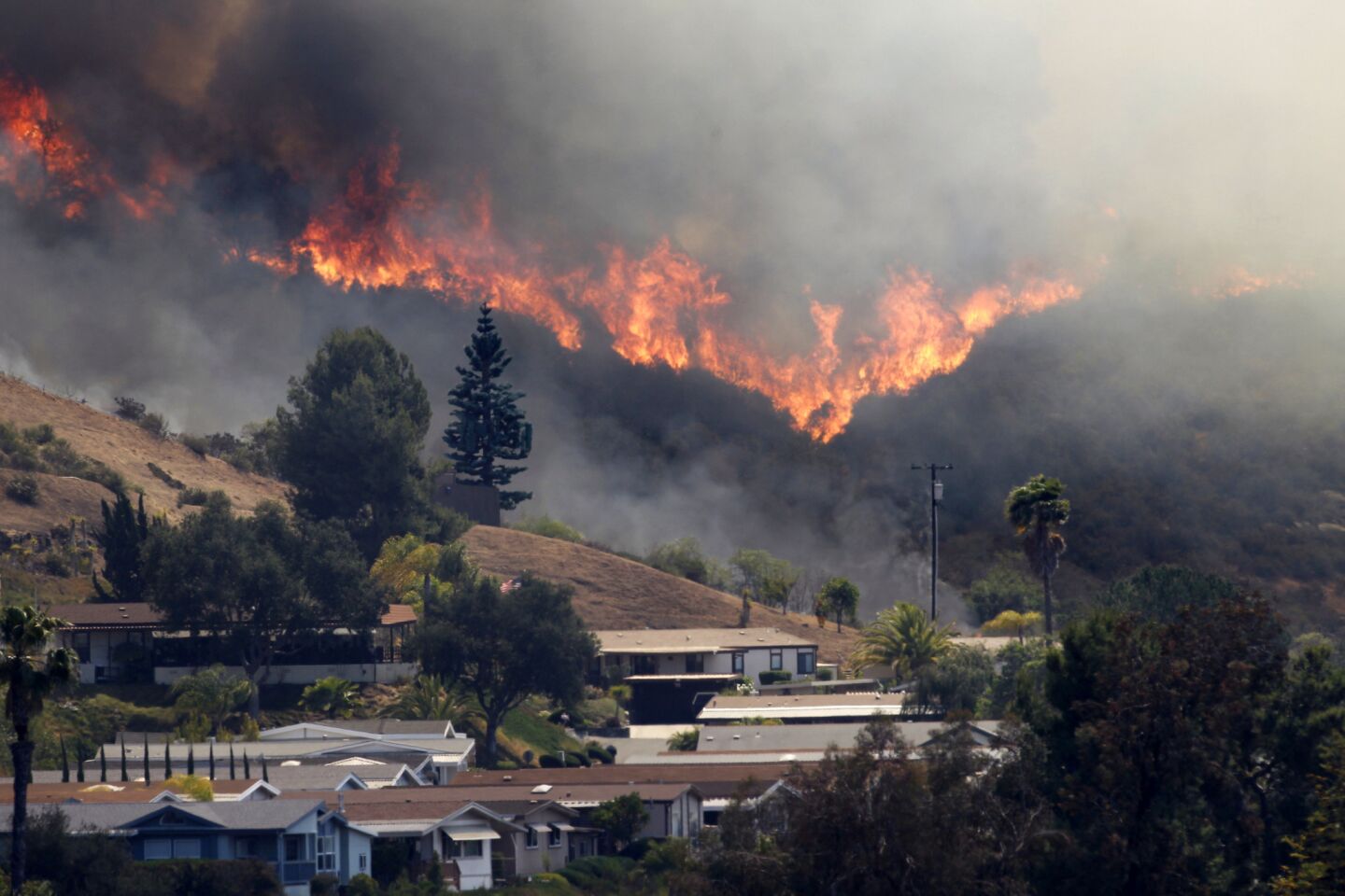 A wildfire burns out of control in the Deer Springs area east of Fallbrook.