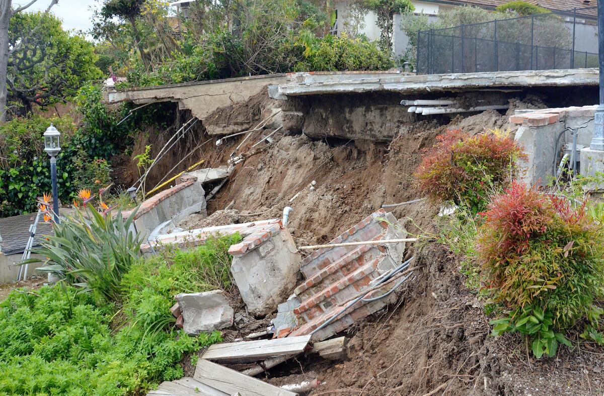 A house located at 1472 Galaxy Drive shows patio damage from a landslide.