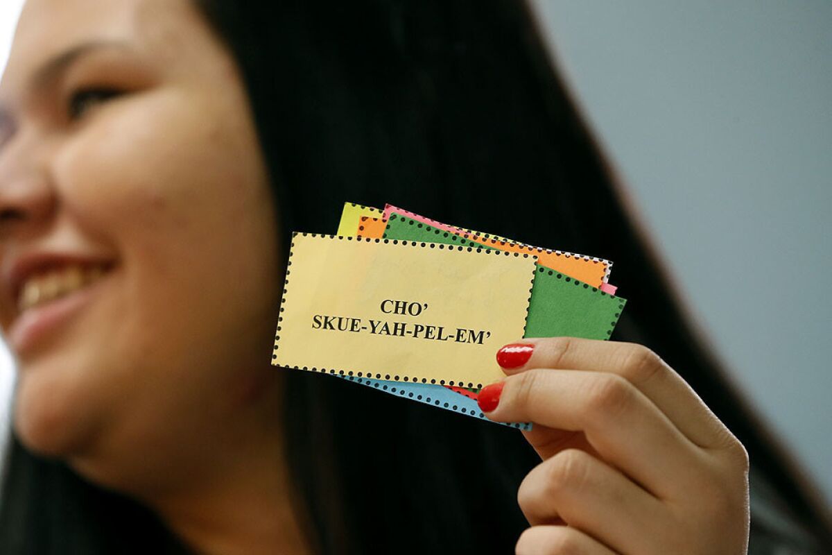 Del Norte High School student Chuski Scott holds up Yurok language flash cards in a class taught by Barbara McQuill.