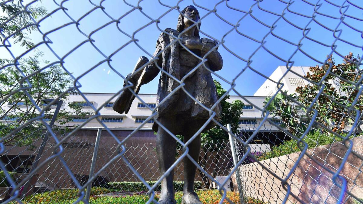 A statue of Christopher Columbus in downtown L.A. is surrounded by a chain-link fence on Oct. 9. Starting in 2019, the second Monday of October in the city and county of L.A. will be called Indigenous People's Day.