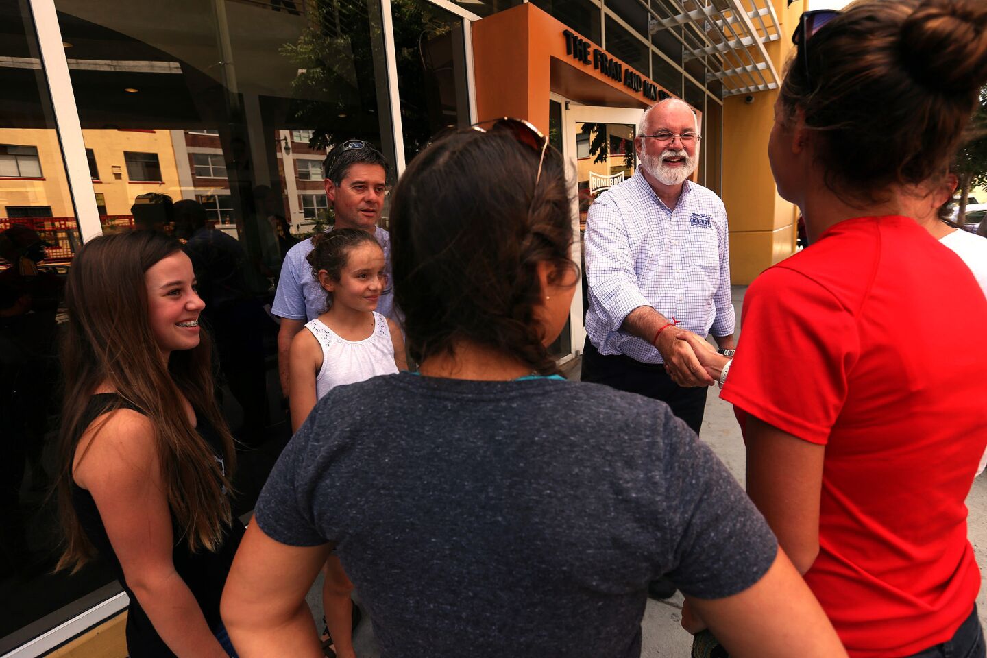 Father Gregory Boyle meets with Bella Newcomb, right, and members of the Snyder family of Santa Cruz. Newcomb is the Snyders' goddaughter.