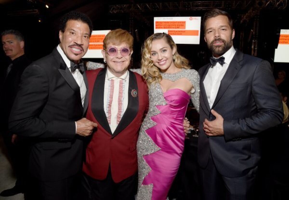 Lionel Richie, left, Elton John, Miley Cyrus and Ricky Martin on Sunday.