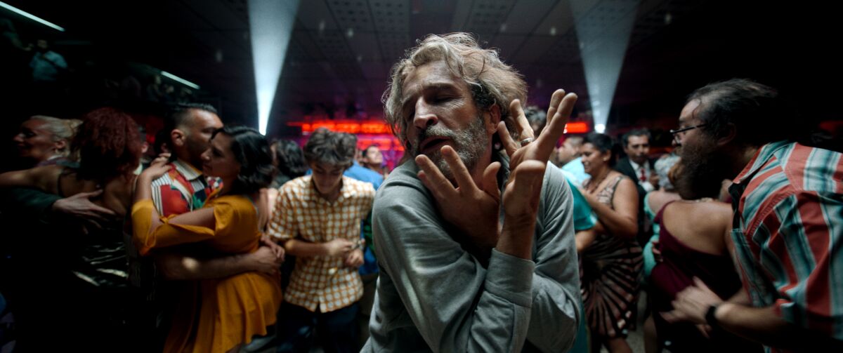 A man dances in a crowded club in a scene from "Bardo, False Chronicle of a Handful of Truths."