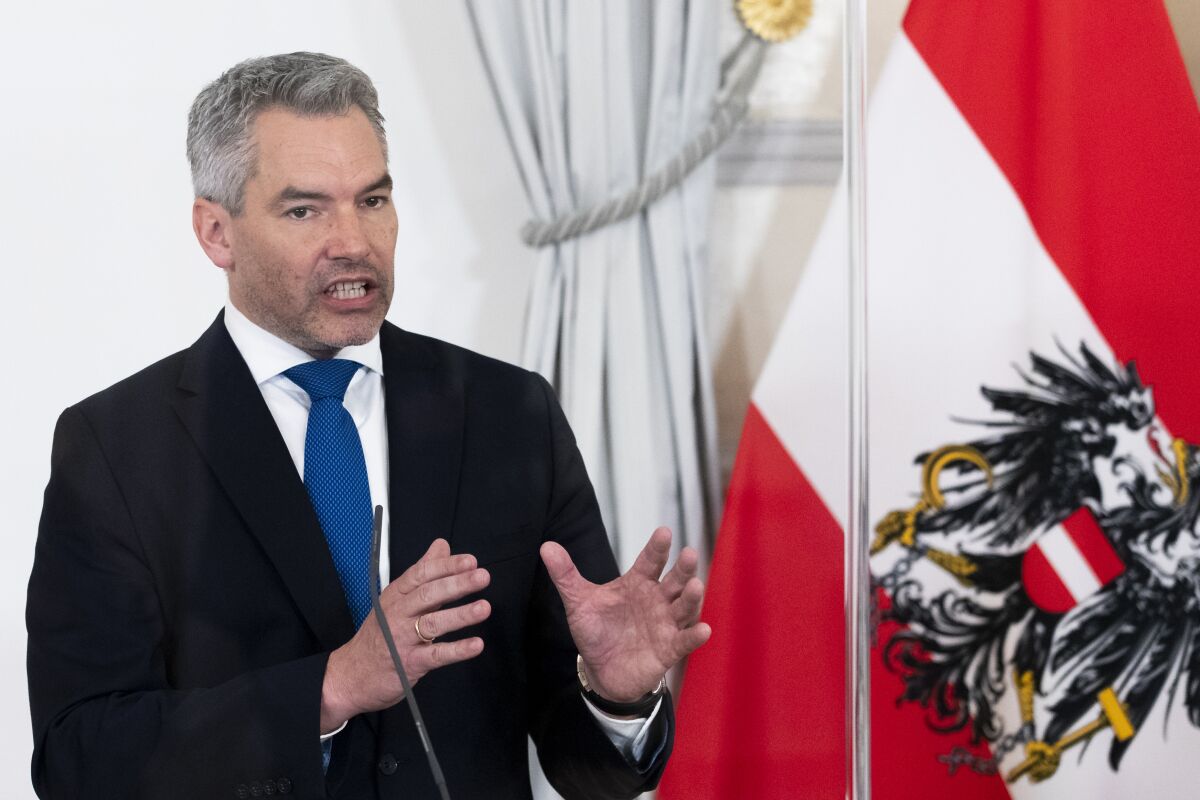 Austria's Chancellor Karl Nehammer presents the new COVID19- regulations at a news conference after a meeting of the Austrian government with the 'Austrian Covid Crisis Coordination Commission' (GECKO) in Vienna, Austria, Wednesday, Feb. 16, 2022. By March 5, 2022 most COVID-19 restrictions will be lifted. (AP Photo/Lisa Leutner)